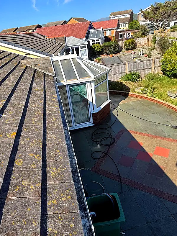 Gutter running along a roof eave, cleared and cleaned