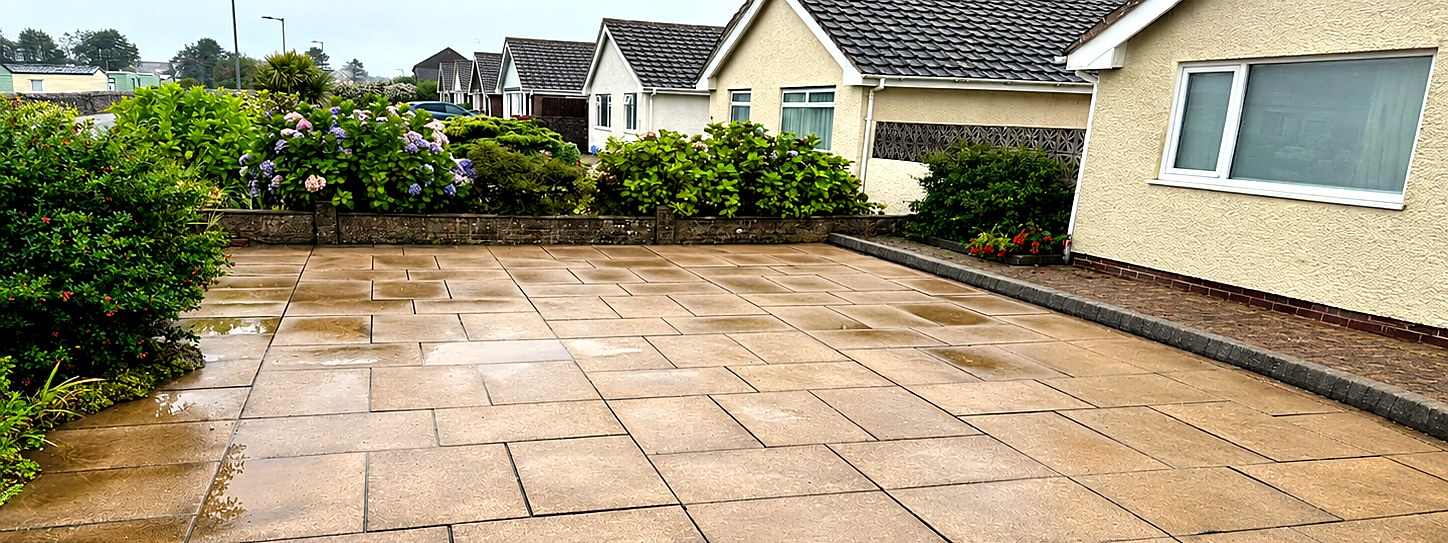 Same patio after pressure washing, clean paving slabs